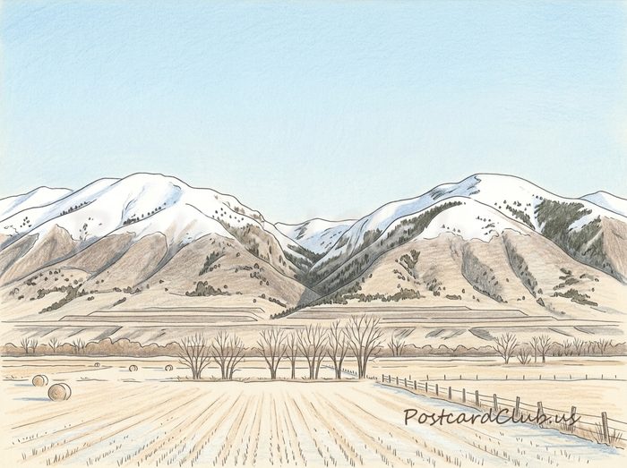 First snow: Snow on the peaks above quiet, frosty fields.